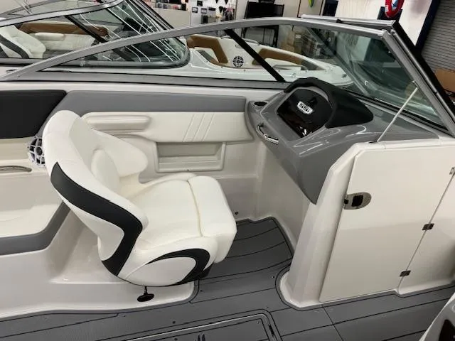 Slide: The Image of 2024 Chaparral 23 SSi OB boat interior with captain's chair and dashboard. - 9