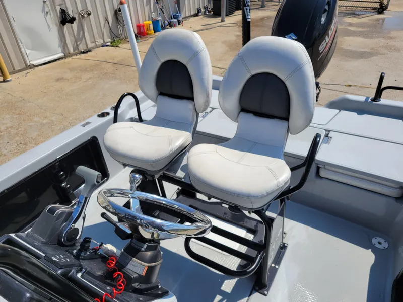 Slide: The Image of 2017 Blue Wave 2200 PureBay boat interior with dual captain's chairs and steering console. - 12