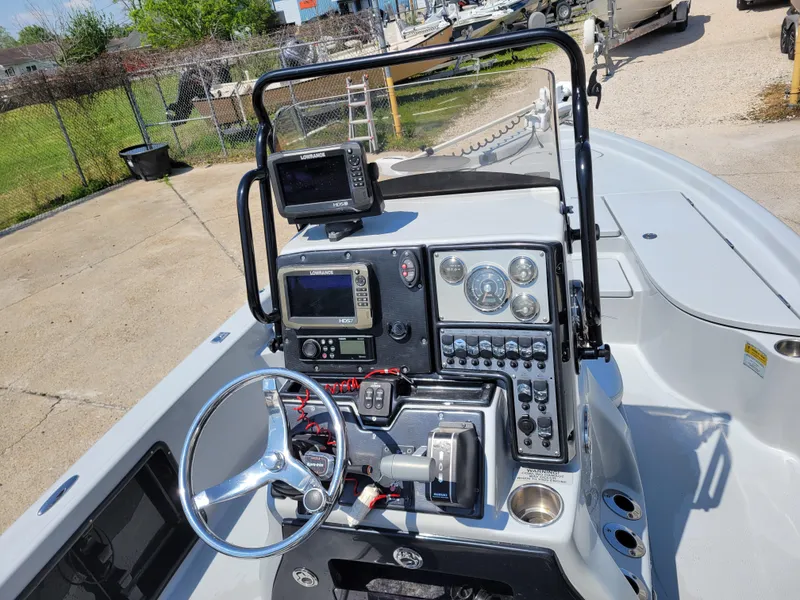 Slide: The Image of 2017 Blue Wave 2200 PureBay boat console with steering wheel, navigation equipment, and control panel. - 16