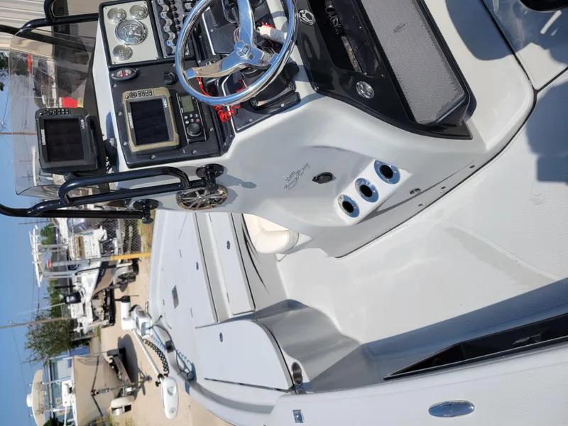 Slide: The Image of 2017 Blue Wave 2200 PureBay boat interior with navigation equipment and steering wheel. - 18