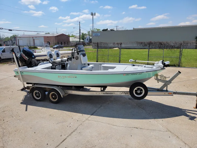 Slide: The Image of 2017 Blue Wave 2200 PureBay boat on a trailer in a parking lot. - 23
