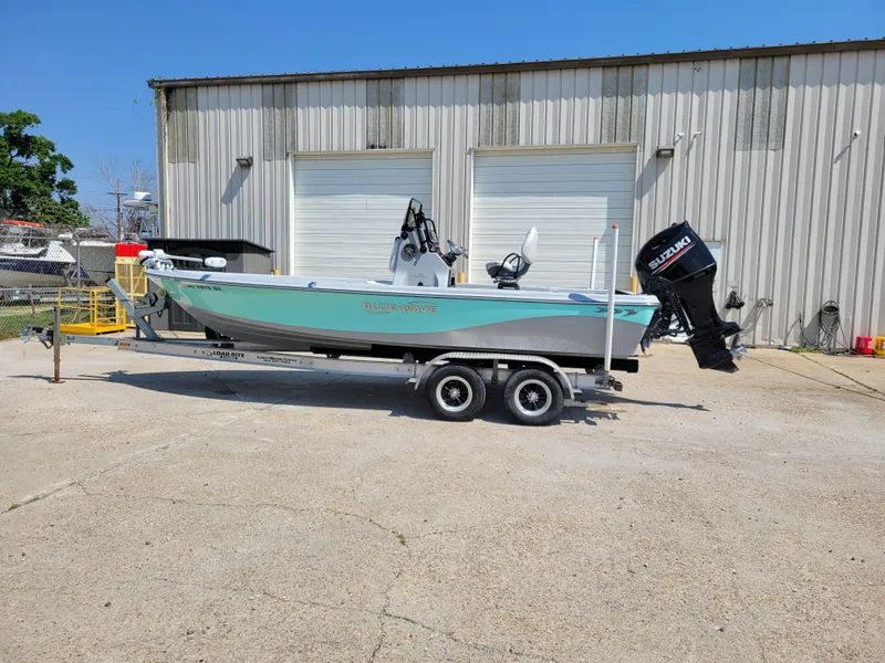 Slide: The Image of 2017 Blue Wave 2200 PureBay boat on a trailer outside a warehouse. - 3