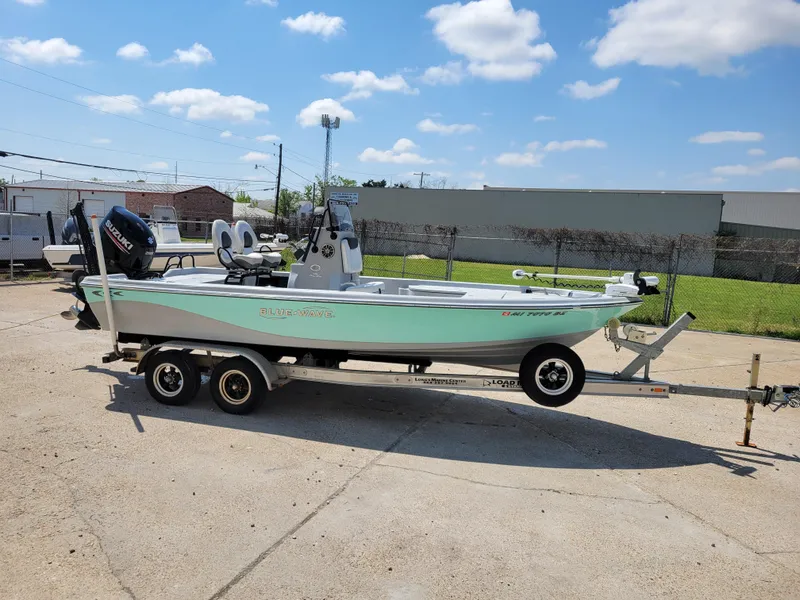 Slide: The Image of 2017 Blue Wave 2200 PureBay boat on a trailer in a parking lot. - 8
