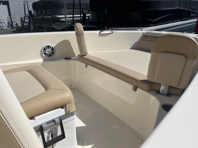Slide: The Image of 2024 Scout 195 Sportfish boat interior with beige seating and storage compartments. - 3