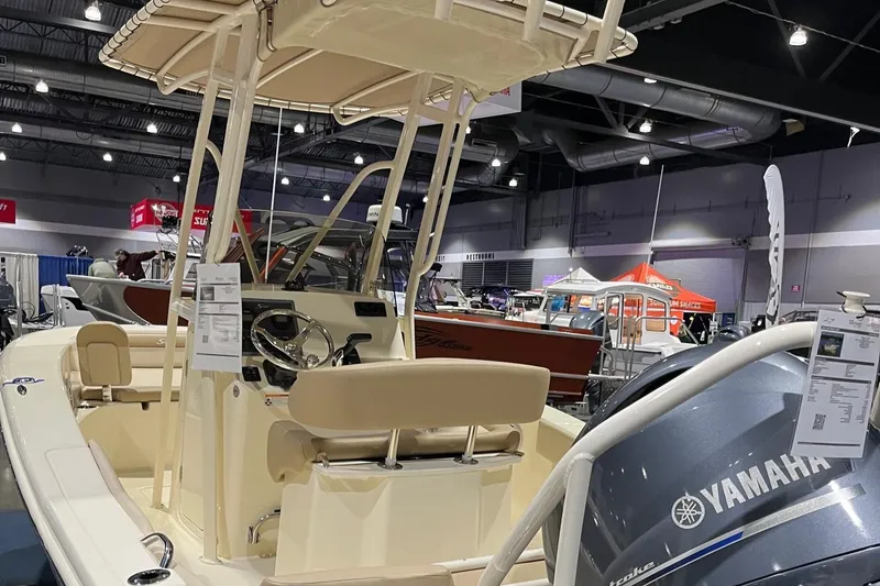 Slide: The Image of 2024 Scout 195 Sportfish boat displayed at an indoor boat show. - 4