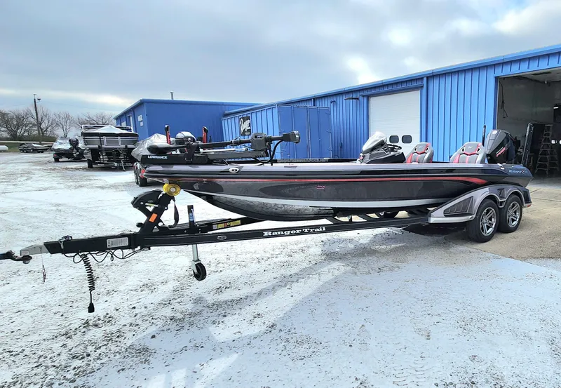 Slide: The Image of 2024 Ranger Z520R Ranger Cup Equipped boat on trailer, parked outside blue building. - 0