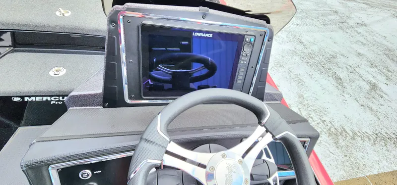 Slide: The Image of 2024 Ranger Z520R boat dashboard with Lowrance display and steering wheel. - 9