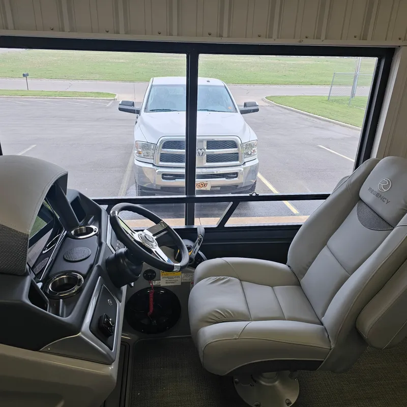 Slide: The Image of Interior view of 2024 Regency 250 LE3 Sport with steering wheel and driver's seat. - 12