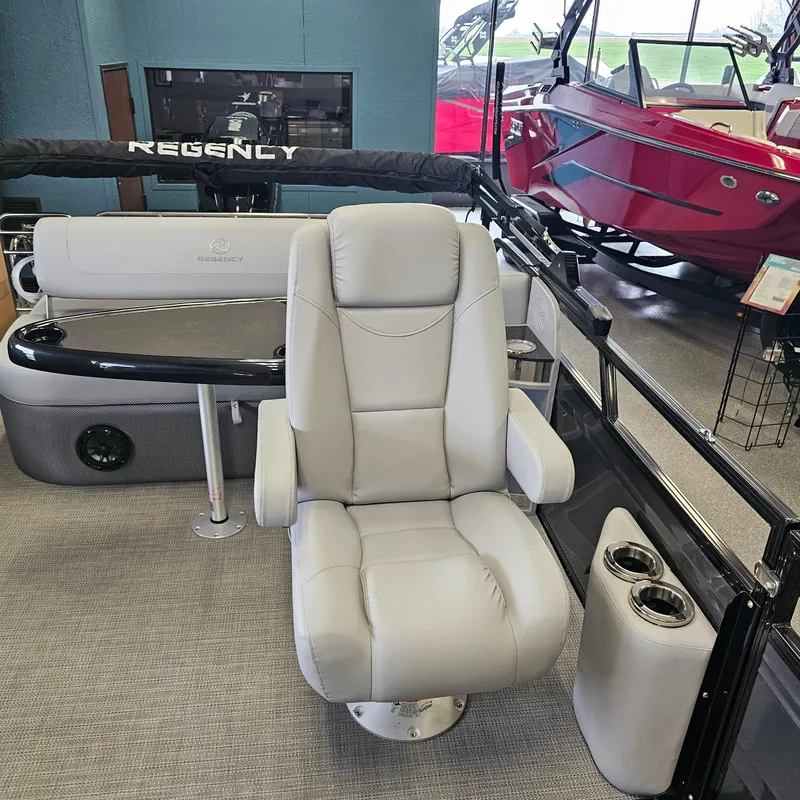 Slide: The Image of 2024 Regency 250 LE3 Sport boat interior with luxurious captain's chair and seating area. - 13