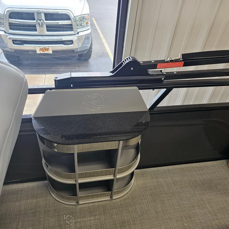 Slide: The Image of 2024 Regency 250 LE3 Sport interior detail with storage compartment and window view. - 26