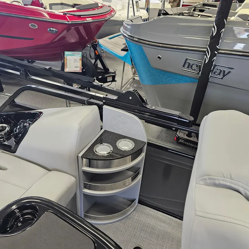 Slide: The Image of 2024 Regency 250 LE3 Sport boat interior with cup holders and seating. - 27