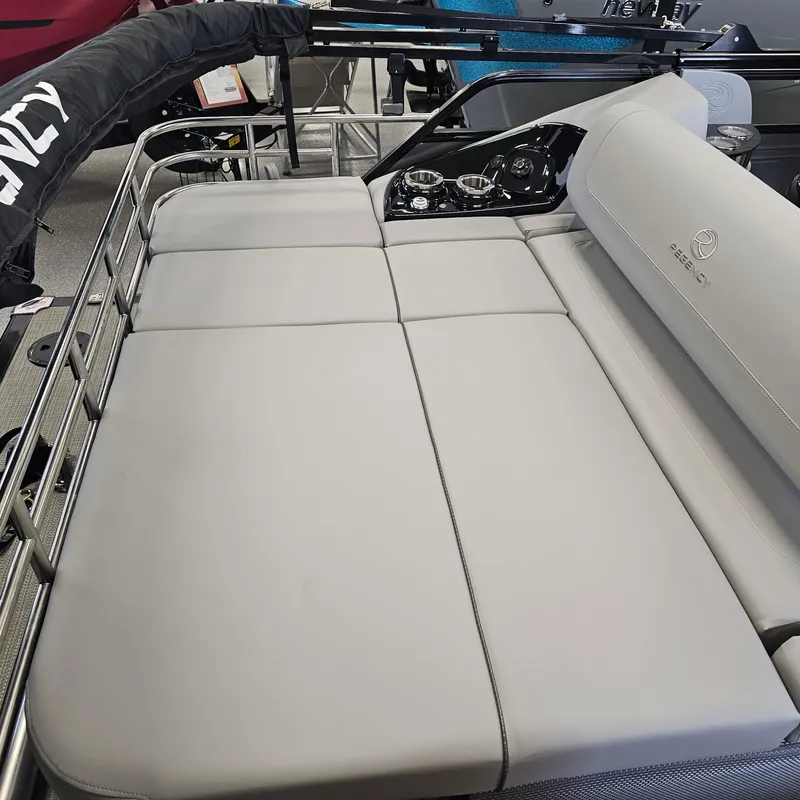 Slide: The Image of 2024 Regency 250 LE3 Sport boat with spacious gray seating area. - 28