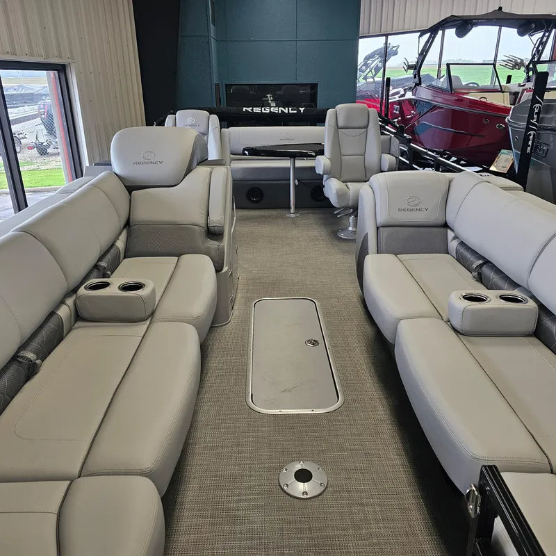 Slide: The Image of 2024 Regency 250 LE3 Sport pontoon boat interior with luxurious seating and cup holders. - 7