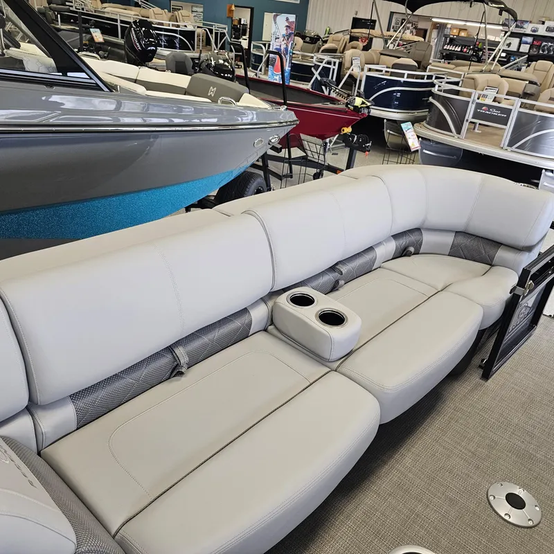 Slide: The Image of 2024 Regency 250 LE3 Sport boat interior with gray seating and cup holders. - 8