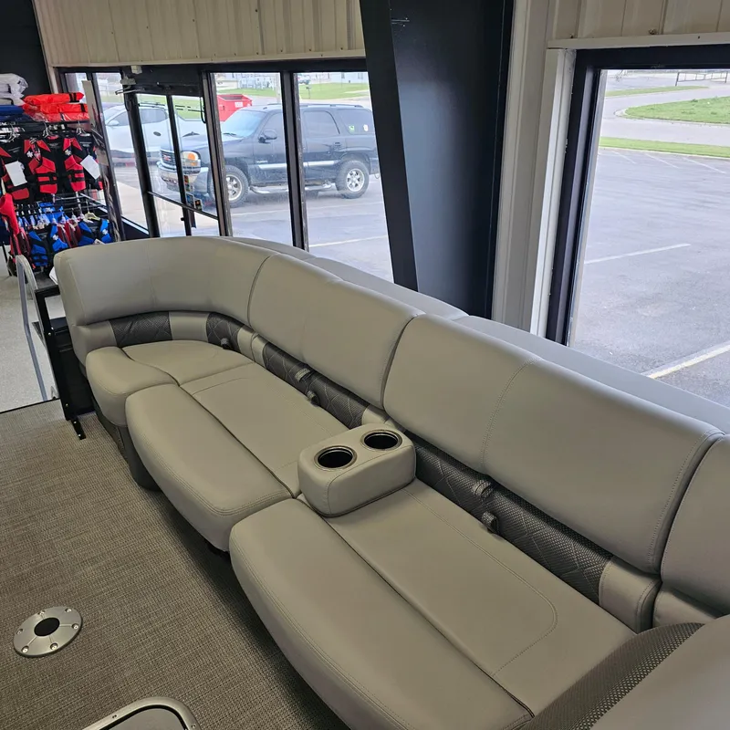 Slide: The Image of 2024 Regency 250 LE3 Sport boat interior with gray seating and cup holders. - 9