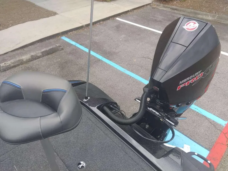 Slide: The Image of 2024 Nitro Z20 Pro boat with Mercury Pro XS outboard motor in parking lot. - 13