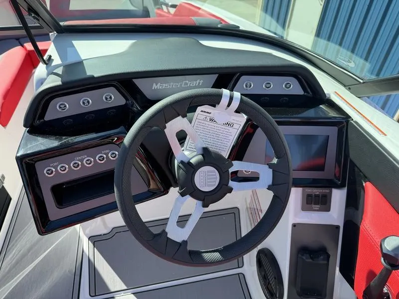 Slide: The Image of 2024 MasterCraft NXT 22 boat dashboard with steering wheel and control panel. - 10