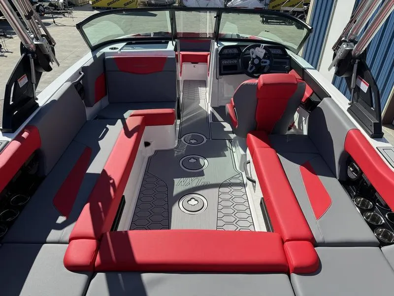 Slide: The Image of 2024 MasterCraft NXT 22 boat interior with red and gray seating. - 18