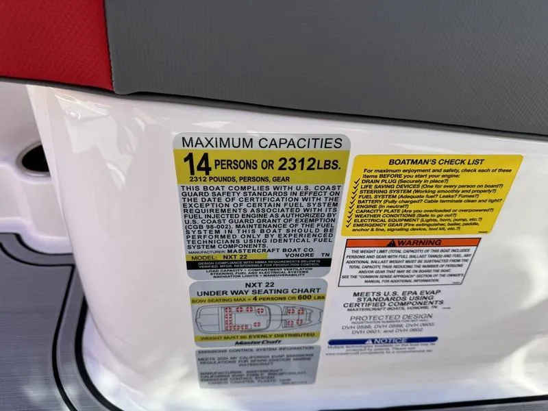 Slide: The Image of 2024 MasterCraft NXT 22 maximum capacities label, 14 persons or 2312 lbs, safety instructions. - 19