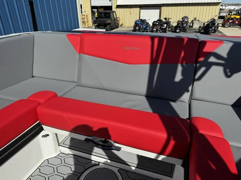 Slide: The Image of 2024 MasterCraft NXT 22 boat interior with red and gray seating. - 23