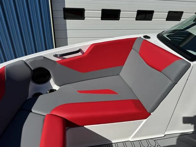 Slide: The Image of 2024 MasterCraft NXT 22 boat with red and gray seating. - 24