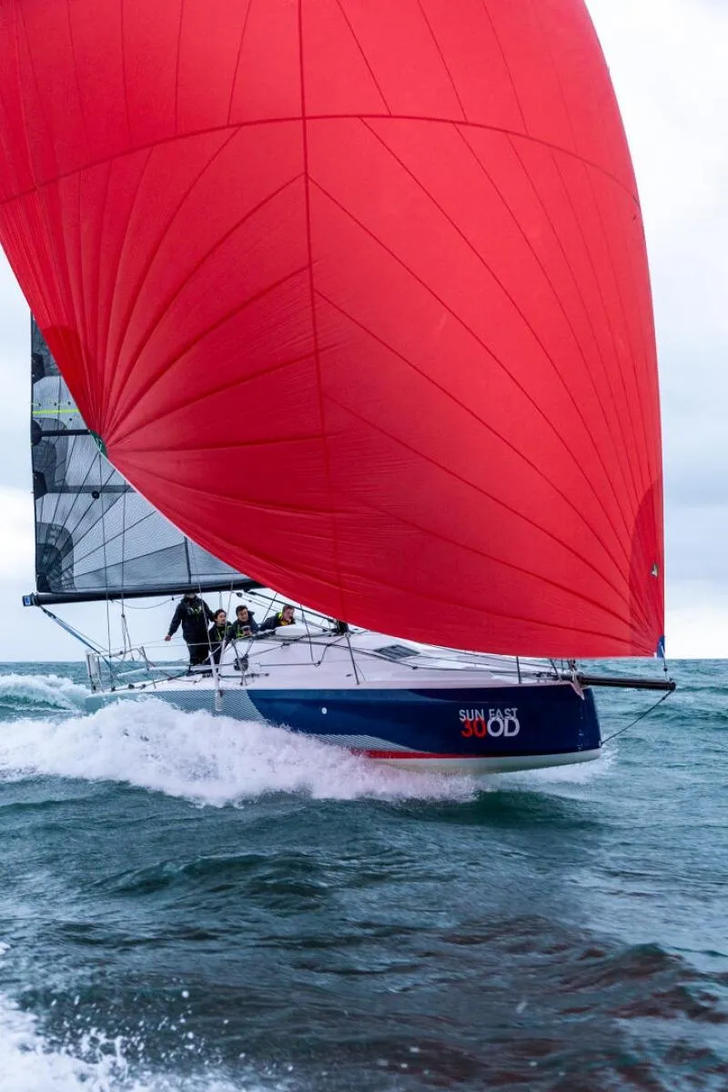 Slide: The Image of 2024 Jeanneau Sun Fast 30 One Design sailing with vibrant red spinnaker. - 7