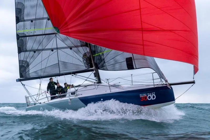 Slide: The Image of 2024 Jeanneau Sun Fast 30 One Design sailboat with red spinnaker on open water. - 8