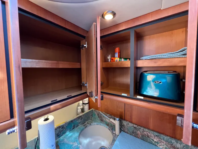 Slide: The Image of Open cabinets in the kitchen of a 2008 Sunseeker Manhattan 50 yacht. - 39