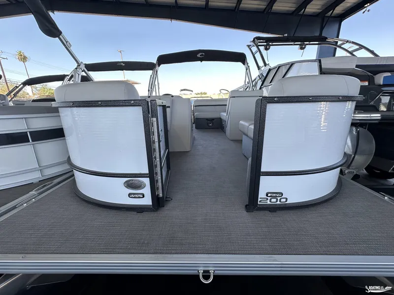 Slide: The Image of 2023 Crest 200 LX L Classic pontoon boat interior with seating and canopy. - 9