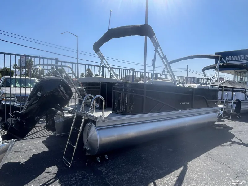 Slide: The Image of 2023 Crest 220 LX L Classic pontoon boat with Mercury outboard motor. - 2