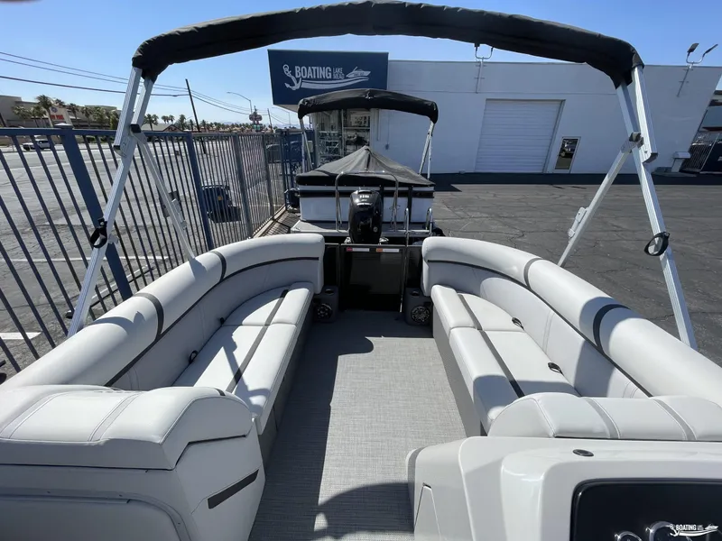 Slide: The Image of 2023 Crest 220 LX L Classic pontoon boat with spacious seating and canopy. - 3