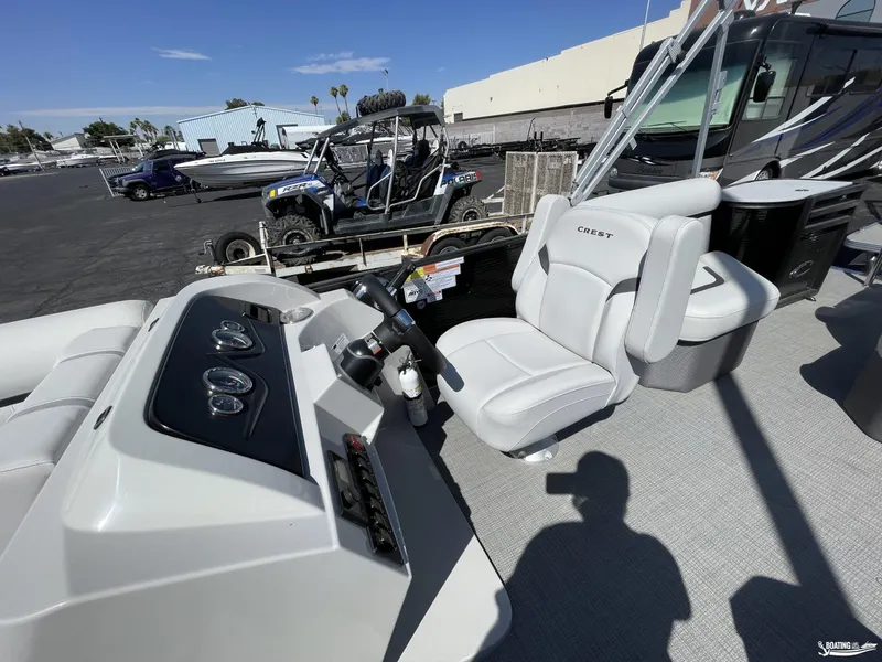 Slide: The Image of 2023 Crest 220 LX L Classic boat interior with captain's chair and control panel. - 4
