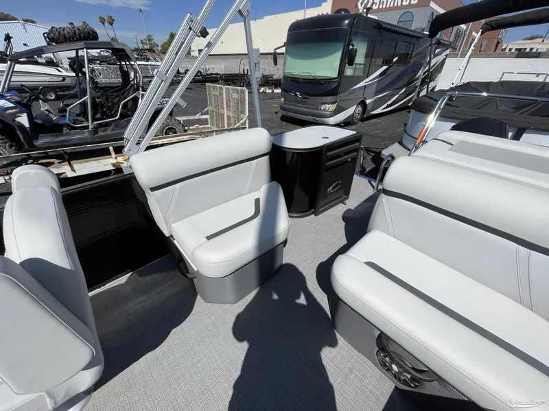 Slide: The Image of 2023 Crest 220 LX L Classic pontoon boat interior with gray seating and modern amenities. - 6
