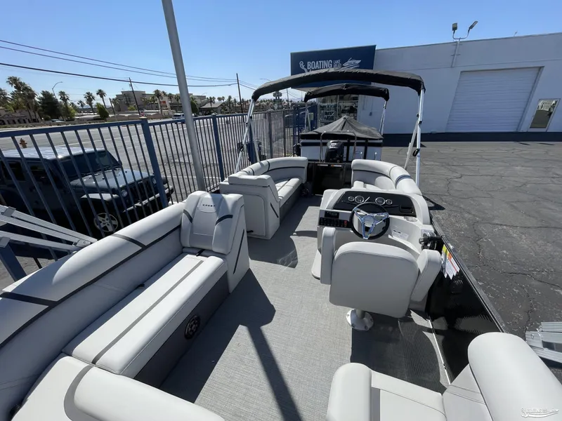 Slide: The Image of 2023 Crest 220 LX L Classic pontoon boat with spacious seating and modern helm. - 7