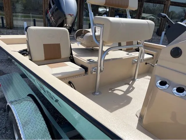 Slide: The Image of 2024 G3 Bay 18 GX boat interior with seating and motor. - 9