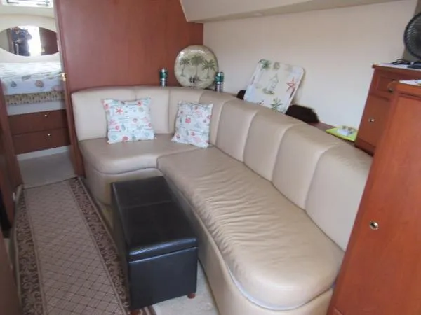 Slide: The Image of Interior of a 2004 Silverton 330 Sport Bridge with beige leather seating. - 11