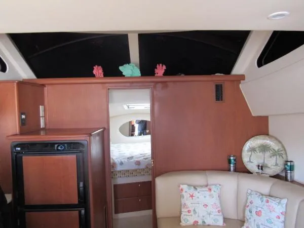 Slide: The Image of Interior of 2004 Silverton 330 Sport Bridge with cozy seating and bedroom view. - 12