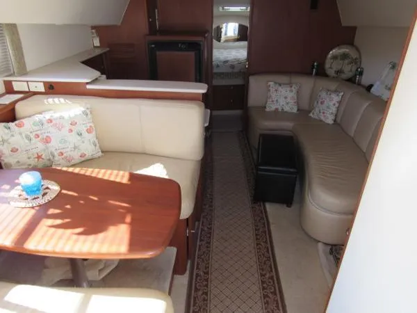 Slide: The Image of Interior of 2004 Silverton 330 Sport Bridge yacht with cozy seating and dining area. - 14