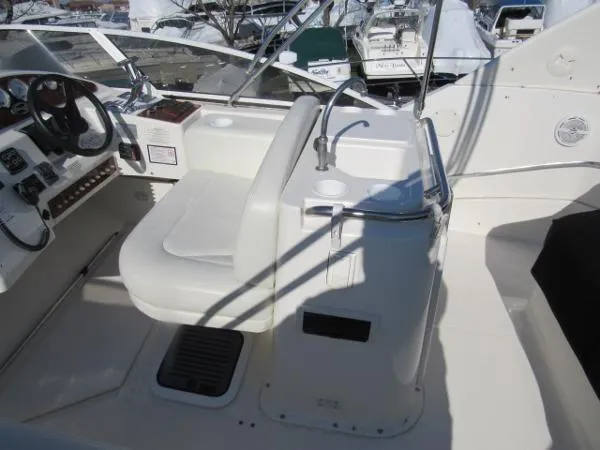 Slide: The Image of 2004 Silverton 330 Sport Bridge cockpit with helm and sink. - 21