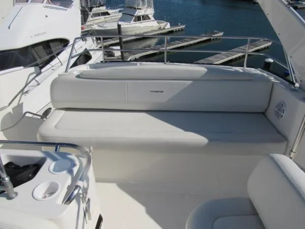 Slide: The Image of 2004 Silverton 330 Sport Bridge boat seating area with marina view. - 22