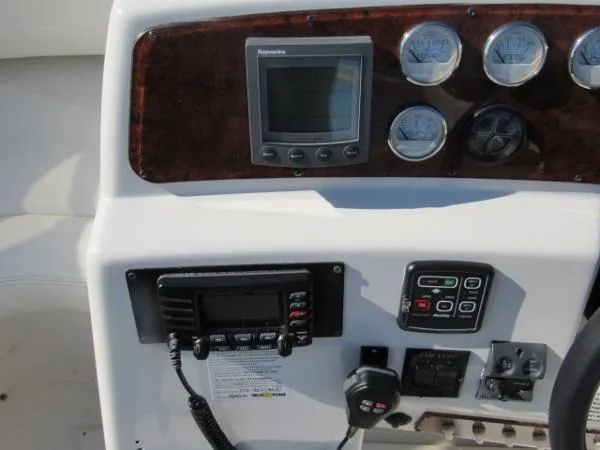 Slide: The Image of Control panel of a 2004 Silverton 330 Sport Bridge boat with navigation and communication equipment. - 24