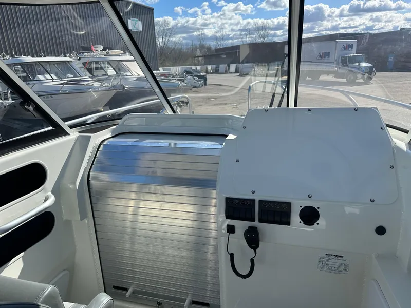 Slide: The Image of Helm and Cabin Rolling door on the 2024 Extreme Boats 795 Walk Around 26' for Sale by Parma Marine - 7