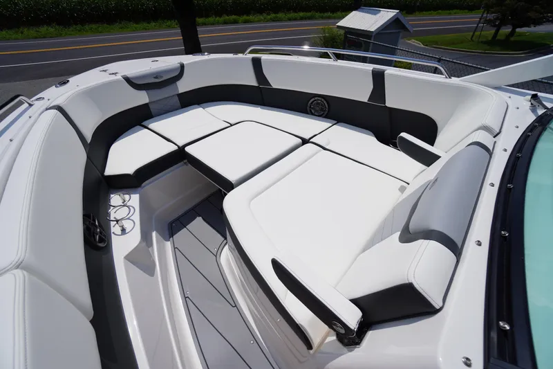 Slide: The Image of 2025 Chaparral 280 OSX boat interior with luxurious white seating and sleek design. - 16