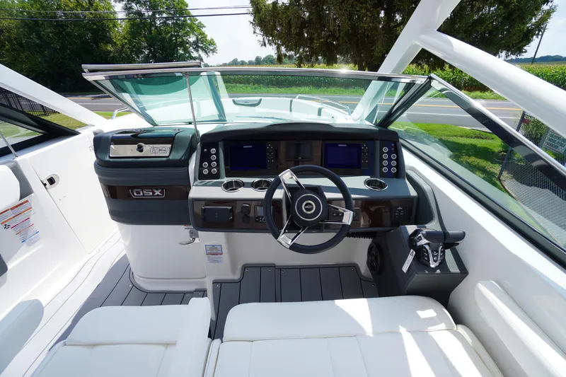 Slide: The Image of 2025 Chaparral 280 OSX boat cockpit with modern steering and navigation controls. - 23