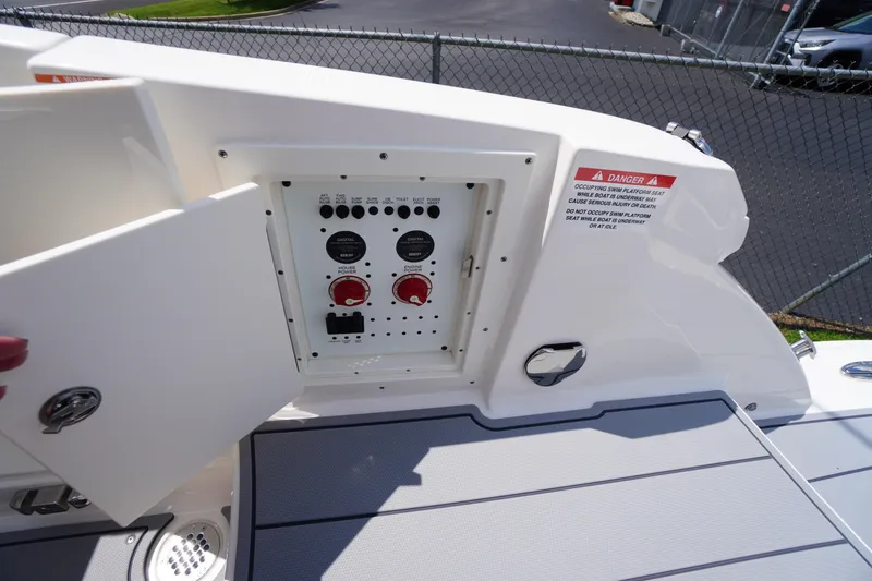 Slide: The Image of Control panel on 2025 Chaparral 280 OSX boat, featuring switches and warning label. - 41