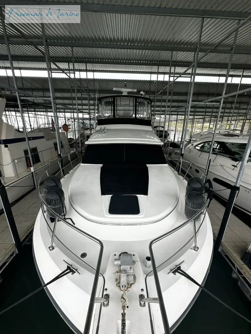 Slide: The Image of 1988 Carver 4207 Aft Cabin yacht docked in marina. - 10