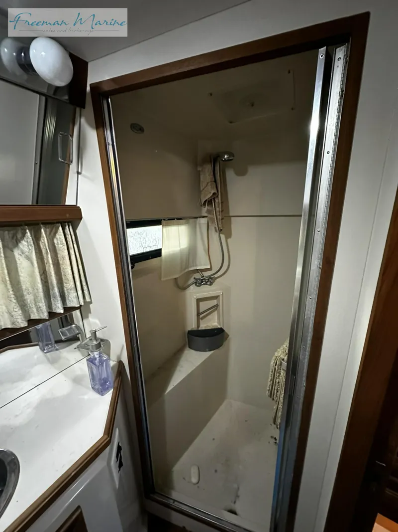 Slide: The Image of 1988 Carver 4207 Aft Cabin shower interior with curtain and fixtures. - 14