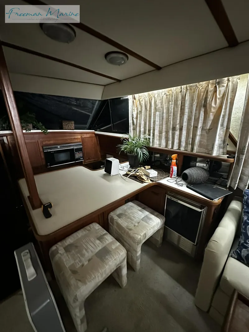 Slide: The Image of 1988 Carver 4207 Aft Cabin interior with kitchen and seating area. - 17