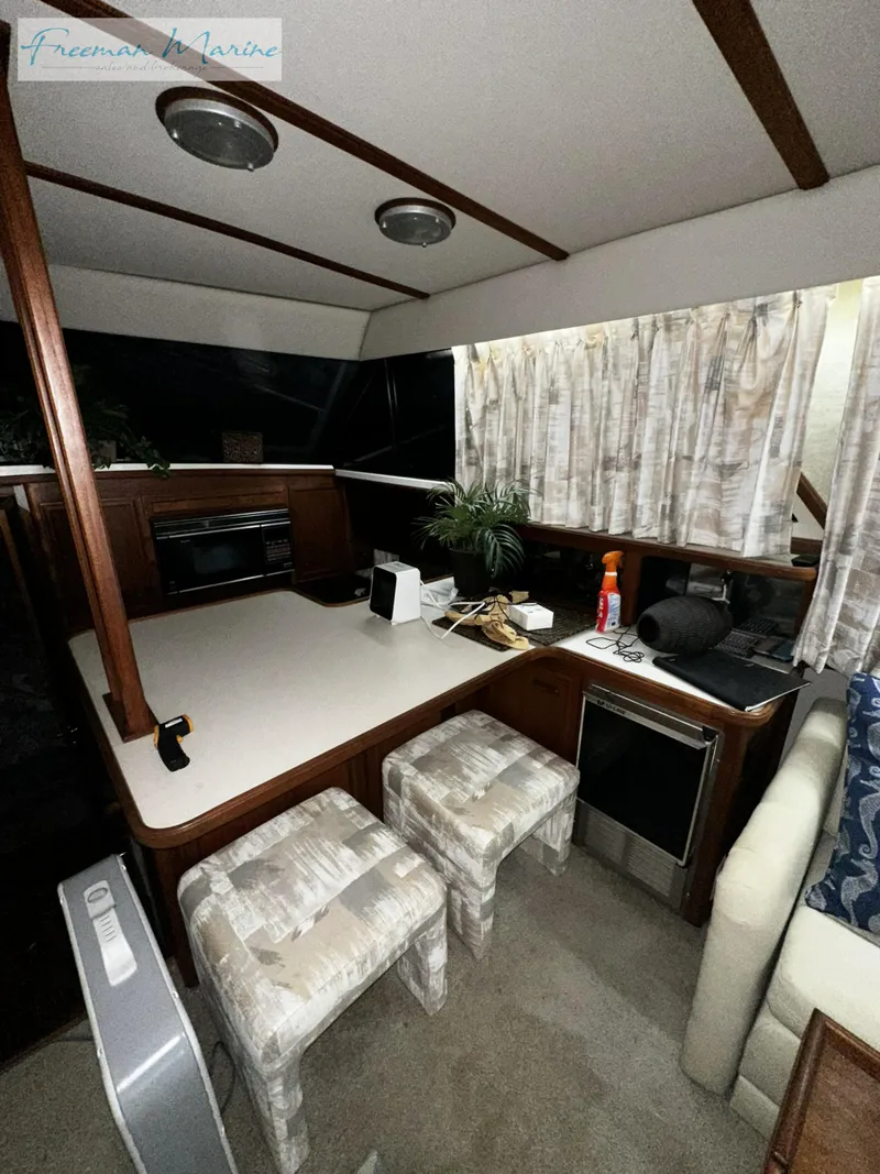 Slide: The Image of 1988 Carver 4207 Aft Cabin interior with kitchen and seating area. - 18