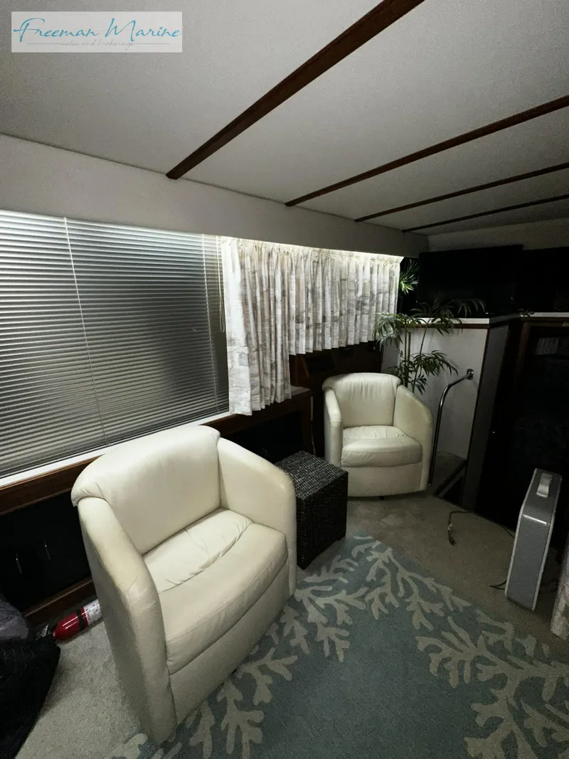 Slide: The Image of Interior of 1988 Carver 4207 Aft Cabin with white chairs and carpet. - 19